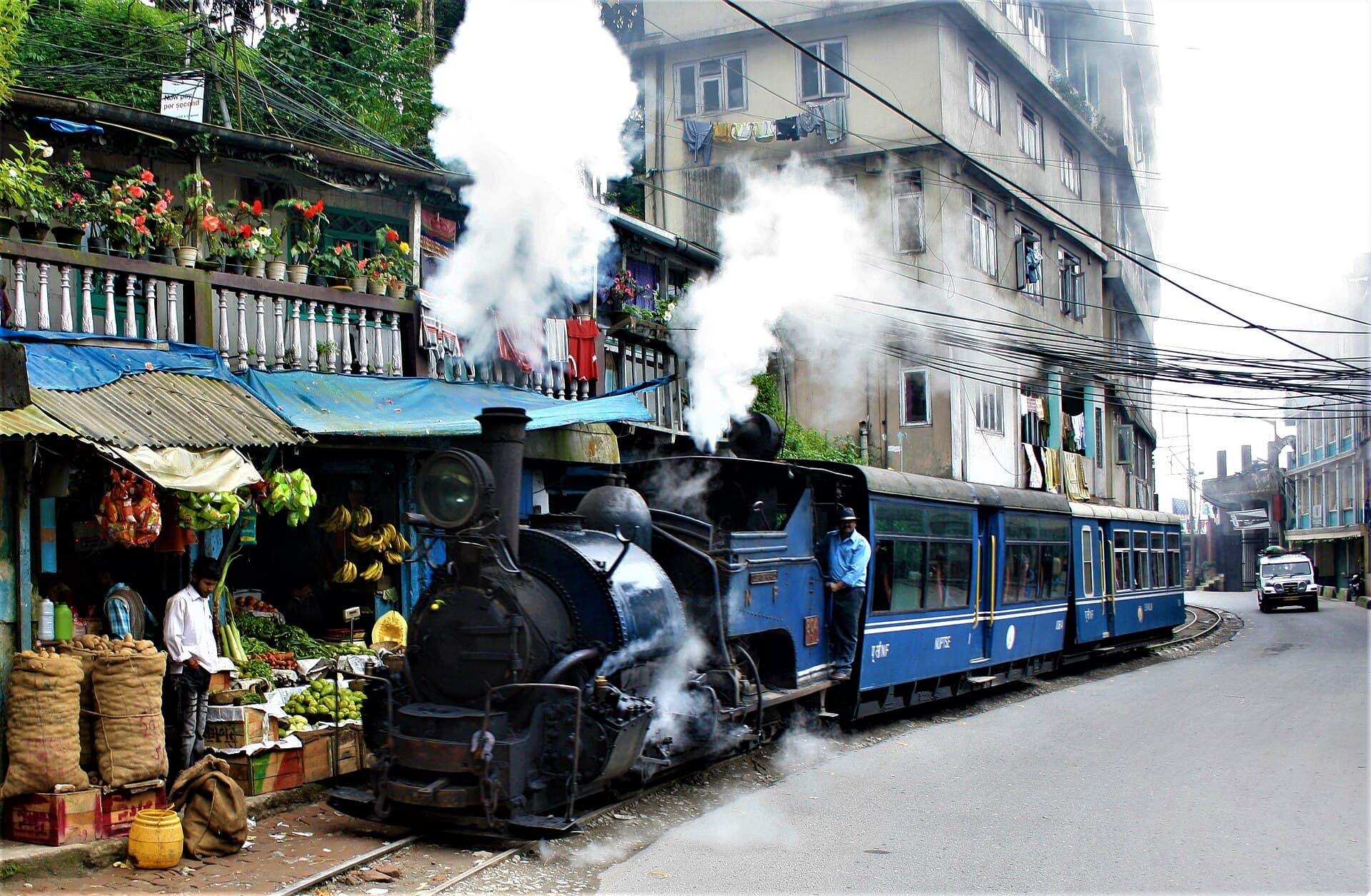Darjeeling Himalayan Railway train beside a local fruit shop